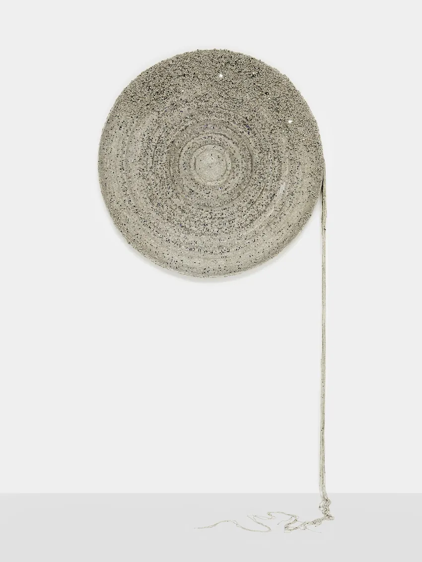 Simphiwe Buthelezi, Nkanyezi (2026), a beaded disc with a strand falling to the floor