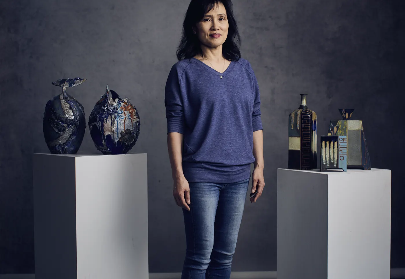 Miae Kim standing between her two bodies of work