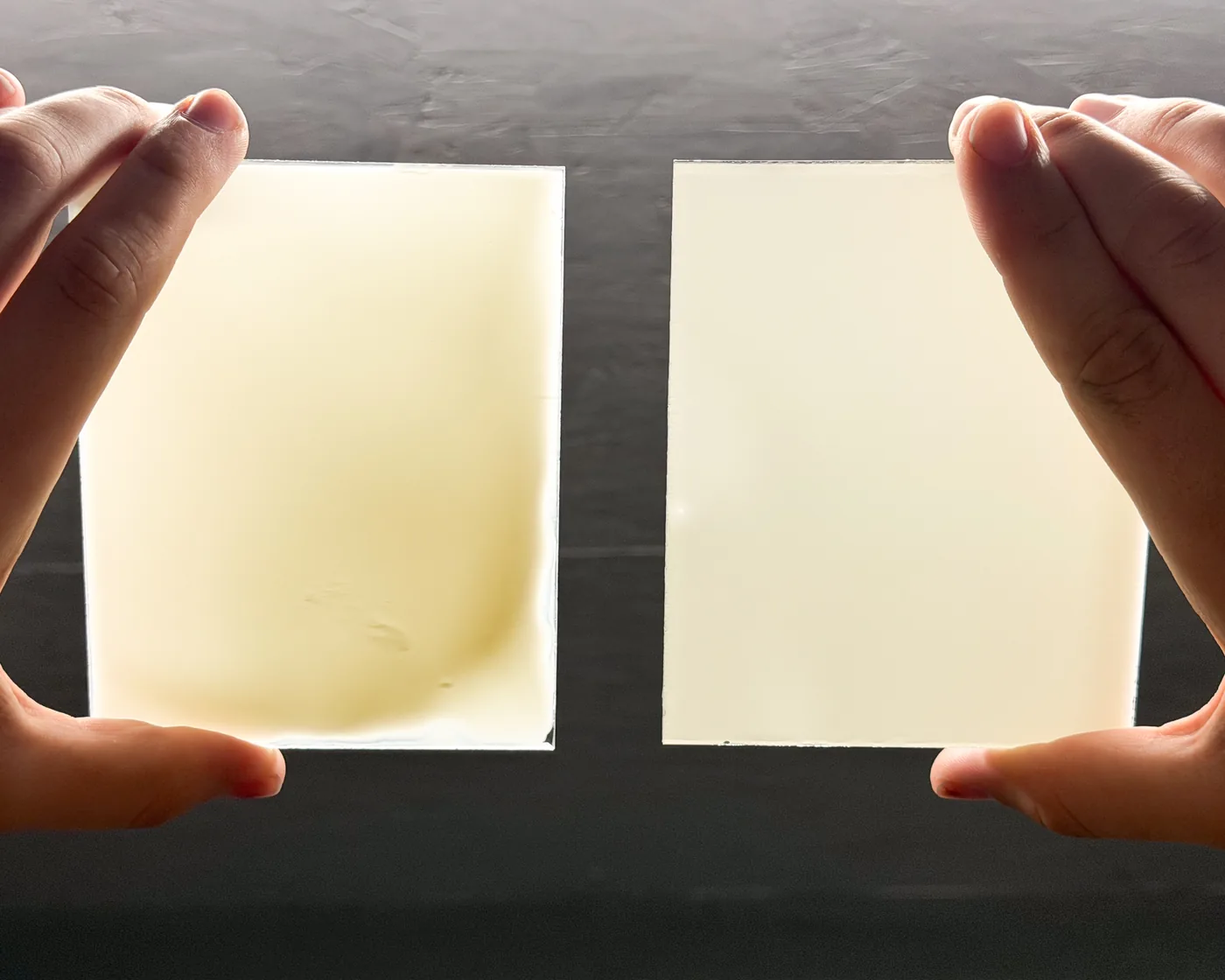 Two coated glass plates held up to the light
